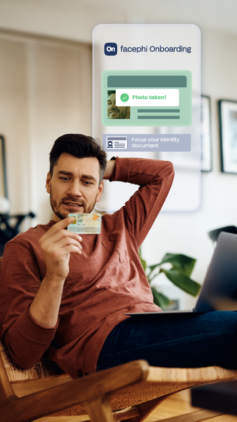 User looking at his national identity card. A floating window in the background shows the result of a successful authentication with Facephi Onboarding